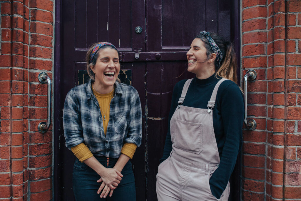 Twin sisters Gabriela and Lucia Evangelou standing outside Cosmic Kitchen in Plymouth