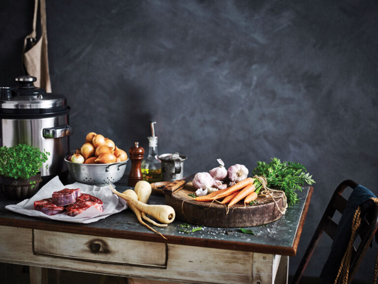 Ingredients on a table next to a slow cooker