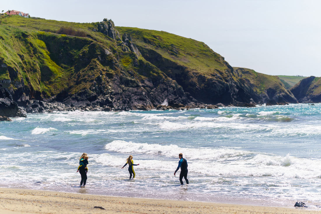 Playing in the sea at Polurrian on the Lizard, family-friendly Easter breaks
