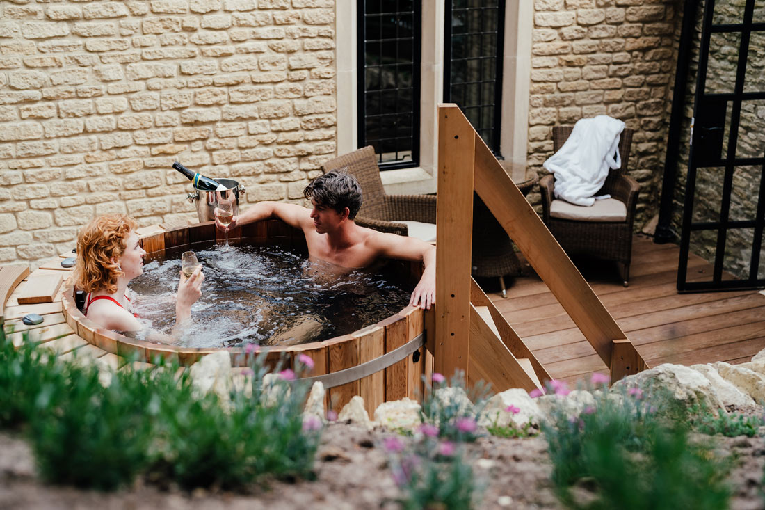 couple in a hot tub at the manor house in wiltshire